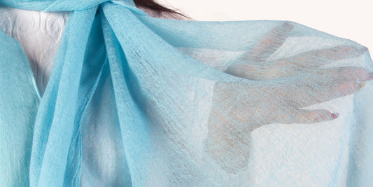 Featured image displaying a model elegantly draped in a cashmere shawl with a striking and unique color combination, emphasizing the texture, quality, and creative color choices to capture the reader's attention and convey the blog post's essence.