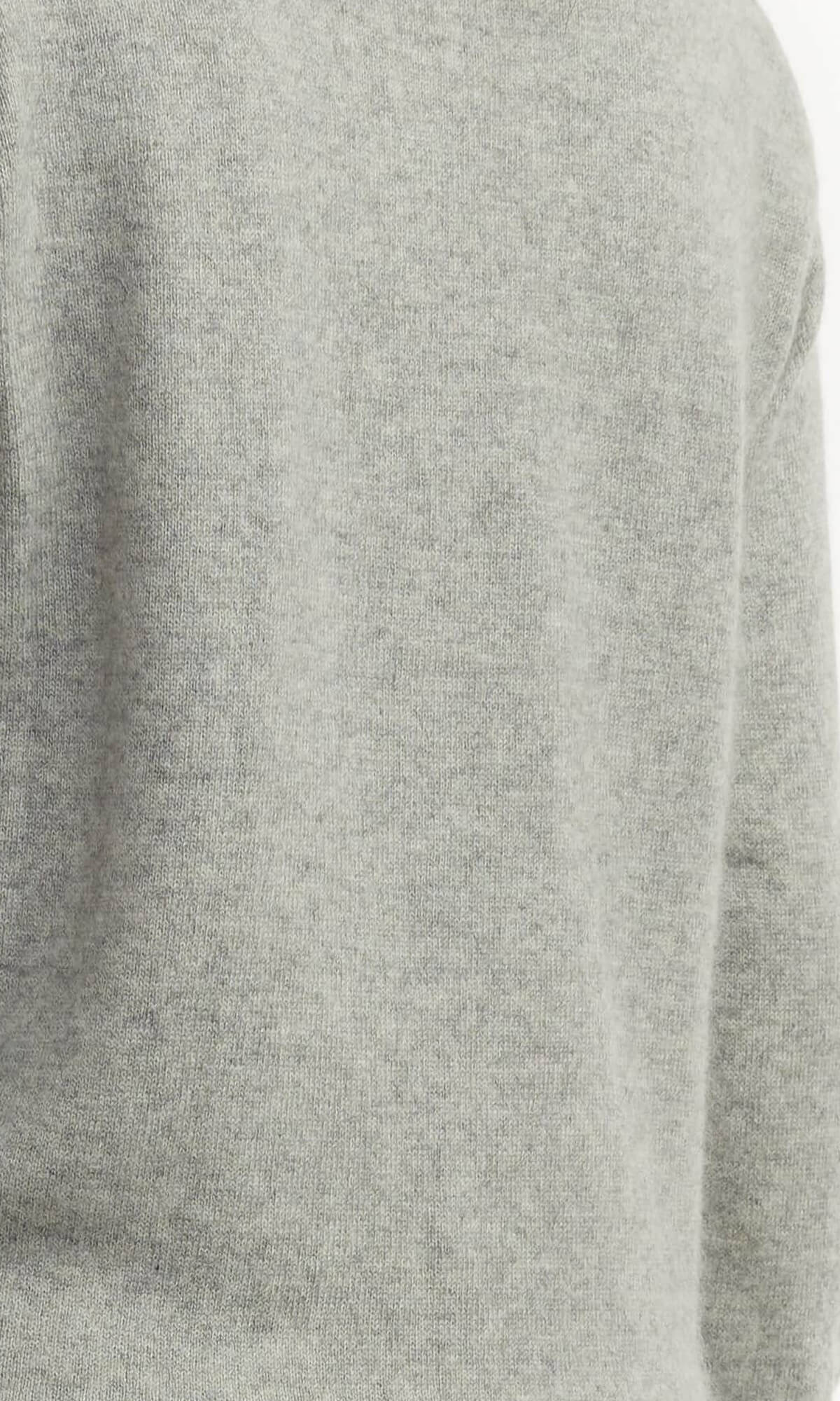 Women's Grey Cashmere Sweater Handmade Knit Close-up View - A luxurious hand-knitted women's cashmere sweater in light grey color, ethically crafted in Nepal