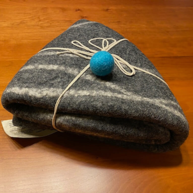 Our handmade felted wool cat cave folded neatly and wrapped with cotton cord ready to be packaged and shipped.