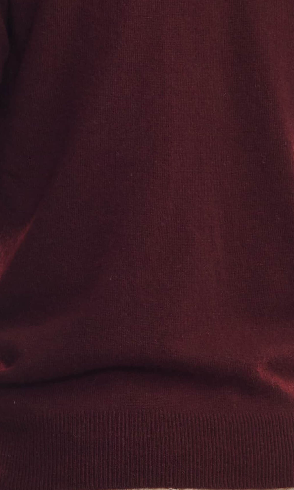 Close-up view of the knit of the rich Bordeaux pure cashmere cardigan in pullover style with roundneck and long sleeves ethically made in Nepal.