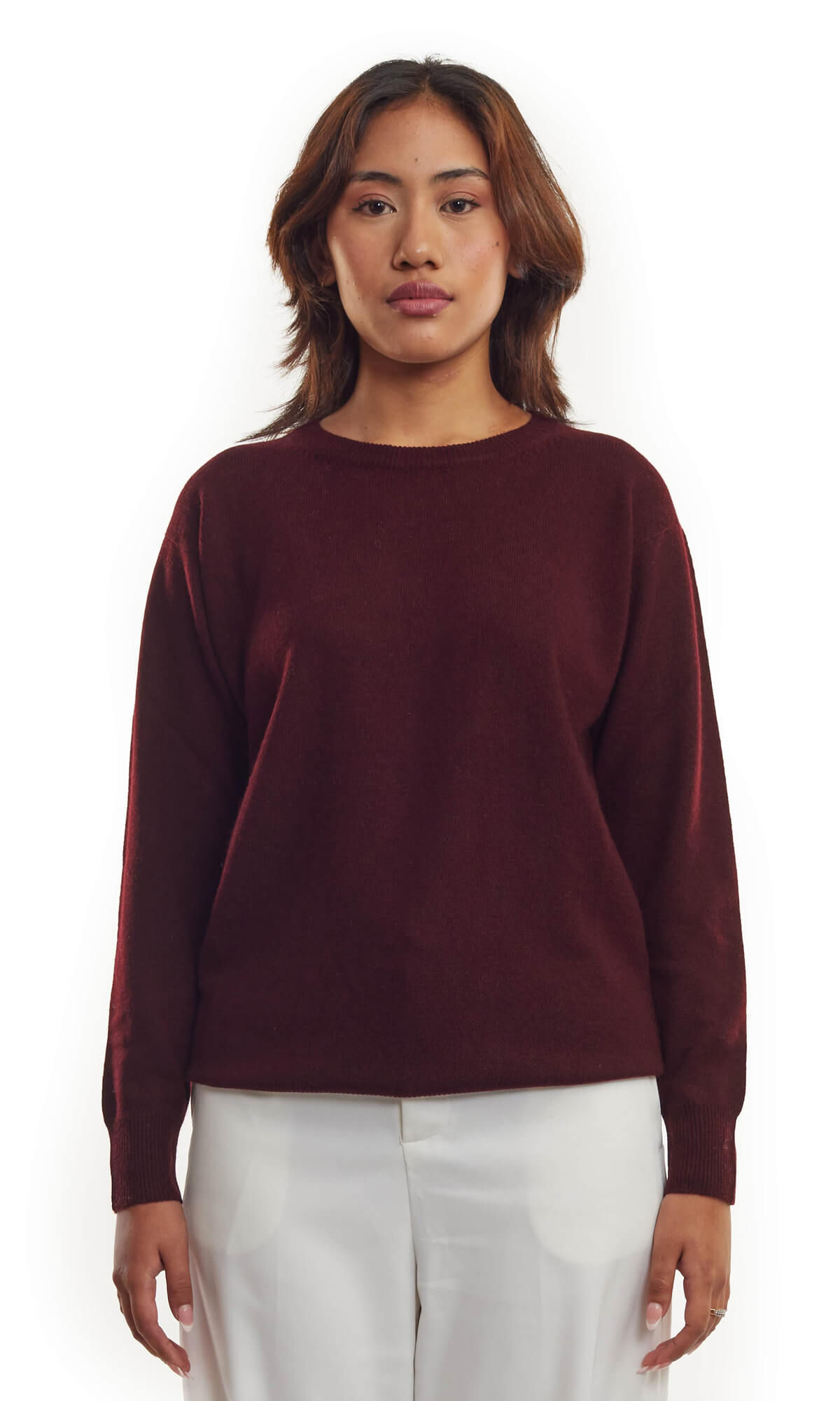 Woman wearing the rich Bordeaux pure cashmere cardigan in pullover style with roundneck and long sleeves ethically made in Nepal; a full front view.