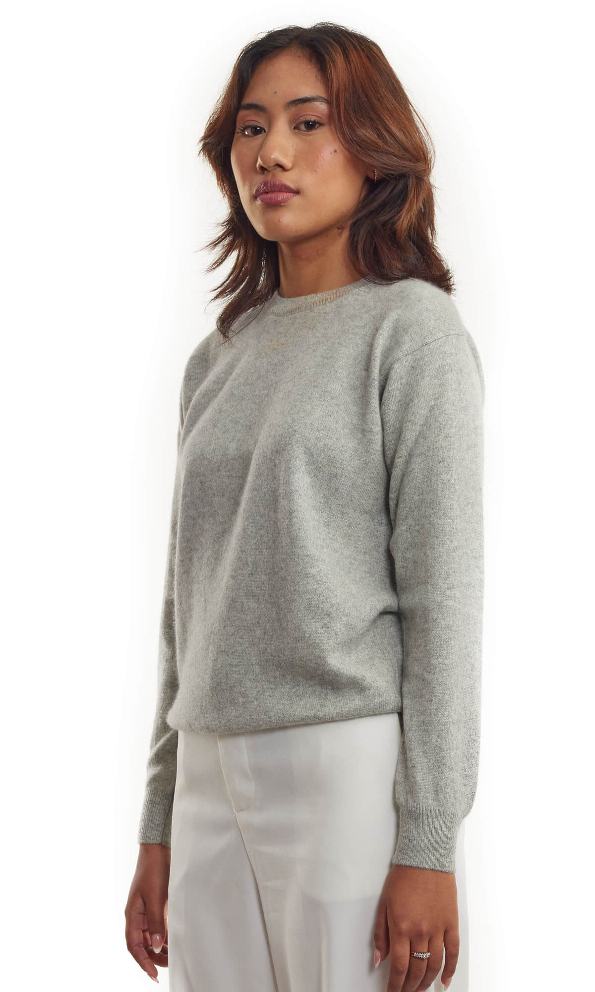 Women's Grey Cashmere Sweater Handmade Angled View - A luxurious hand-knitted women's cashmere sweater in light grey color, ethically crafted in Nepal