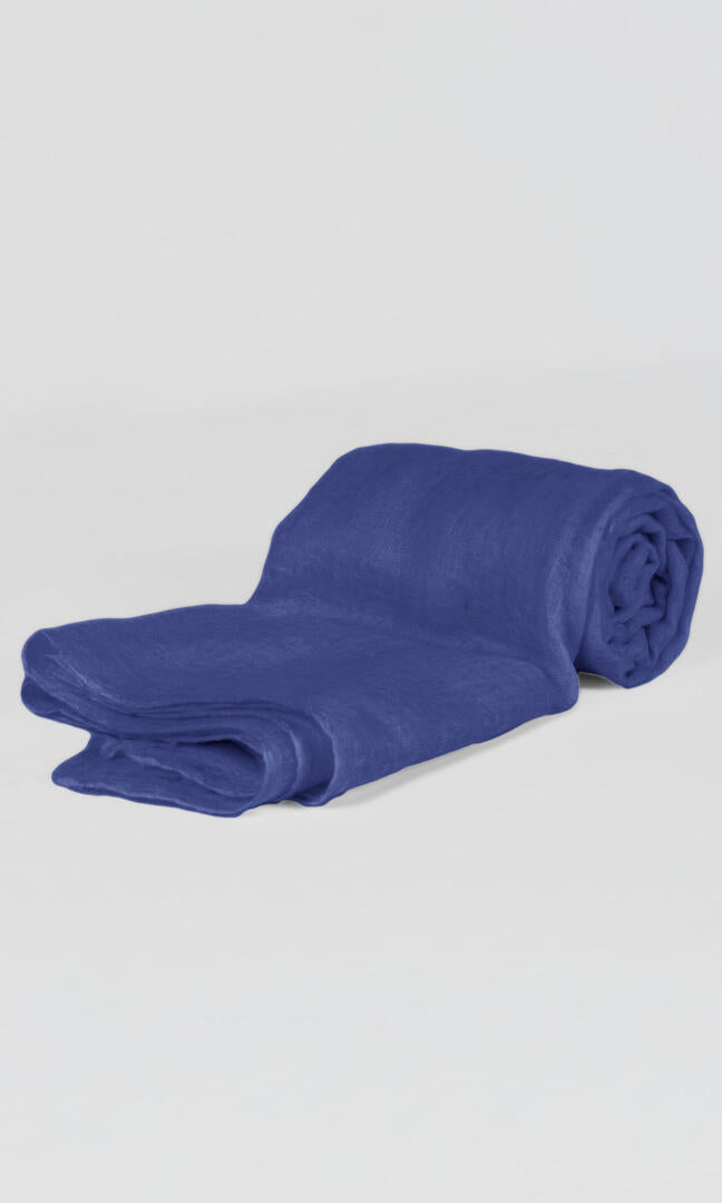 Close-up of the premium handwoven 100% pure Aniline Blue cashmere shawl - flat rolled view to convey its easy-to-pack feature.