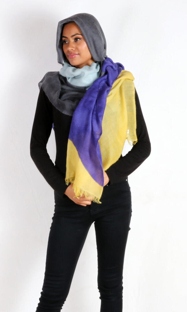 A beautiful model with a stunning and eye-catching super lightweight four-color cashmere romance shawl drapes beautifully over her head.
