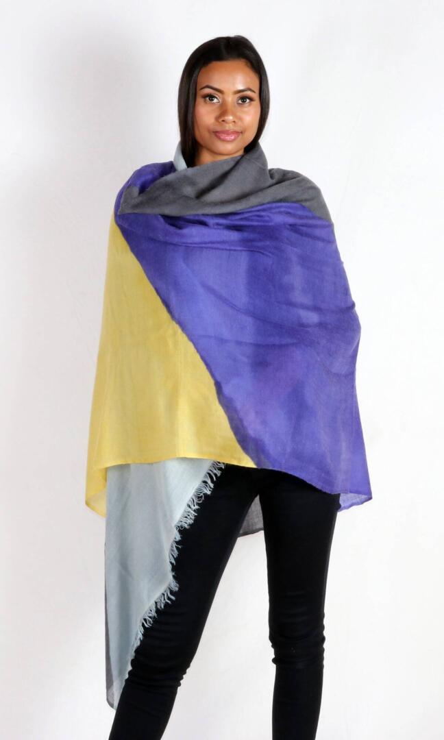 A beautiful model with a stunning and eye-catching super lightweight four-color cashmere romance shawl wrapped around her body evokes feelings of romance and elegance.