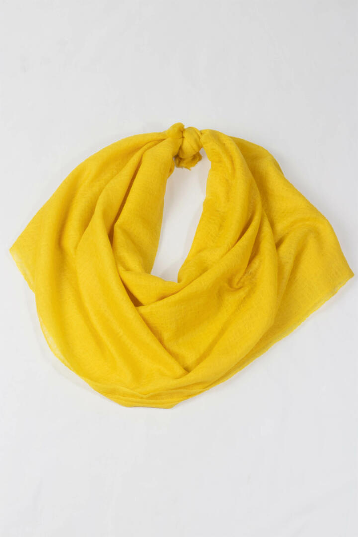 A detailed view of handwoven 100% Pure Emperor Yellow Cashmere Shawl with two ends tied to display a nice round loop.