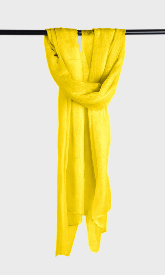 Full view of the premium handwoven 100% pure Buttercup Yellow cashmere shawl hanging from a bar to display its silhouette.