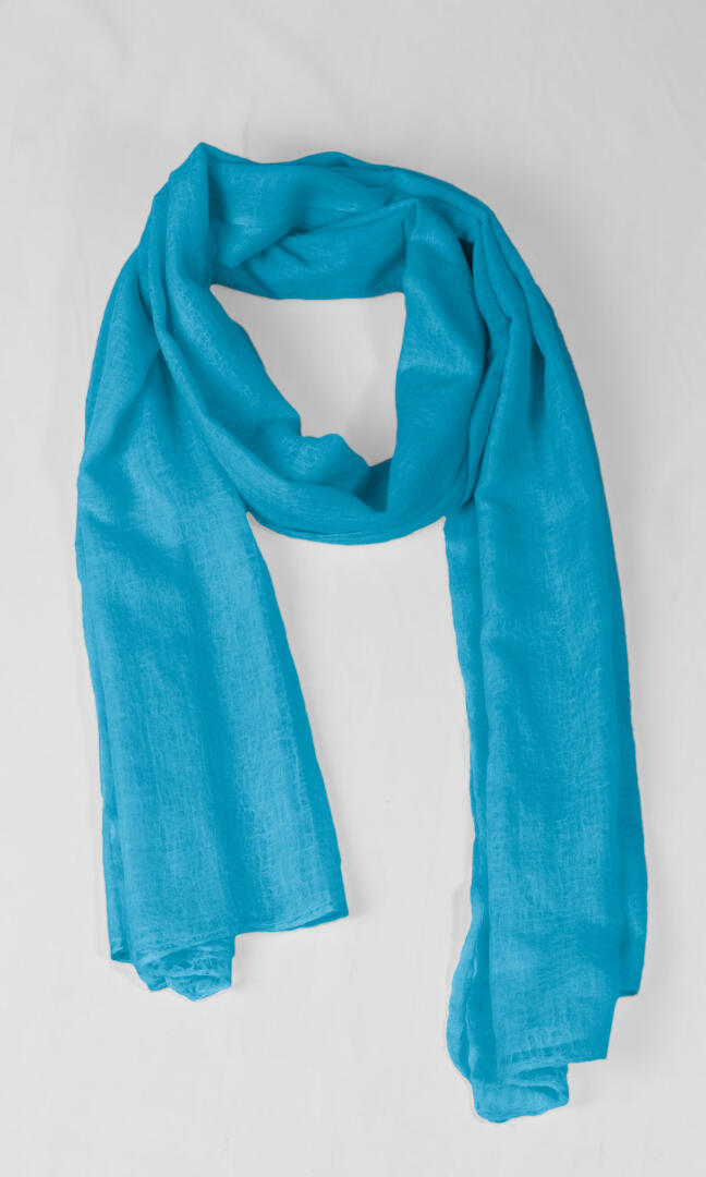 A detailed shot of the premium handwoven 100% pure Celeste Blue cashmere shawl in a seasonless loop shape.