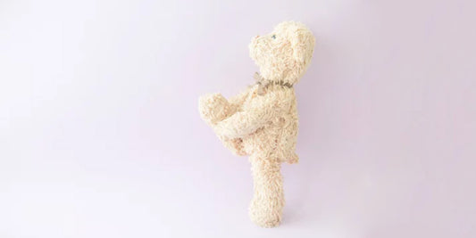 A weighted stuffed animal, a plush toy designed to provide warmth and security through added weight for deep-pressure tactile stimulation, relaxation, and potential therapeutic benefits.