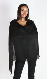 A beautiful 5ft 8 inches tall female model displays a 100% pure handmade black cashmere shawl wrapped around her body to convey the message that the shawl is big enough to use as an evening wrap.