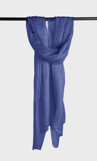 Full view of the premium handwoven 100% pure Aniline Blue cashmere shawl hanging from a bar to display its silhouette.