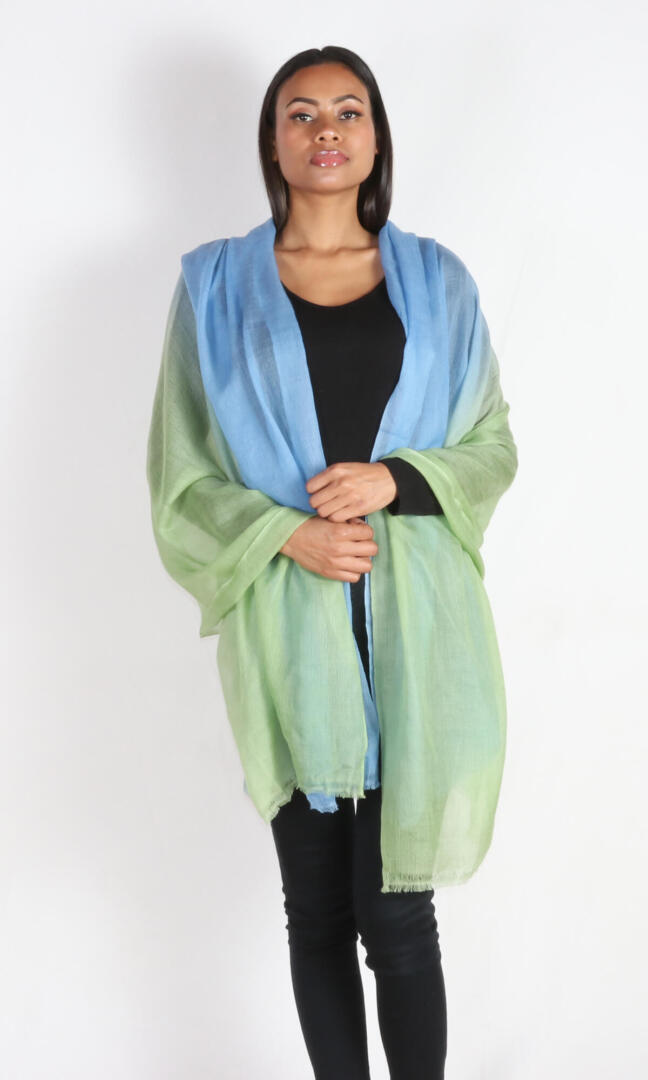 A beautiful model with a super light two-color cashmere car shawl draped over her shoulders.