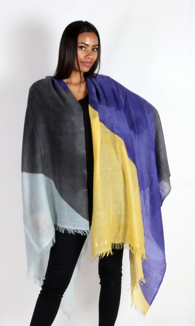 A beautiful model with a stunning and eye-catching super lightweight four-color cashmere romance shawl draped over her shoulders.