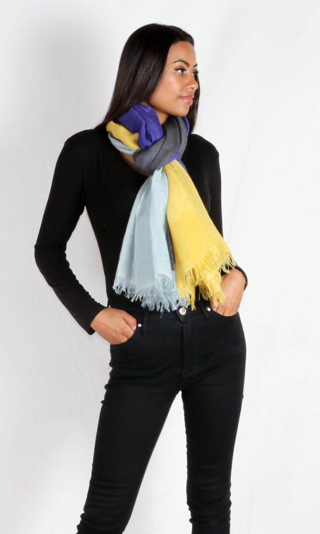 A beautiful model ties the stunning and eye-catching super lightweight four-color cashmere romance shawl around her neck as a winter scarf.