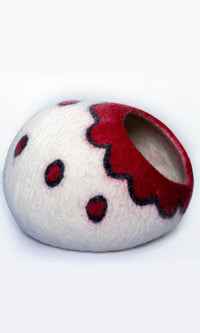 A felted wool cat cave with a Scarlet Blossom flower design entrance, and a full right-side view.