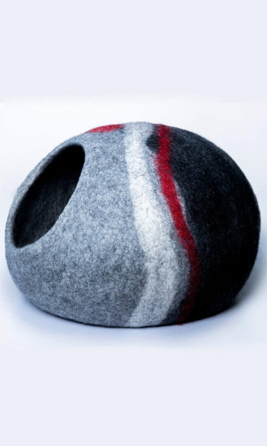 Image of Glamorous Zebra Cat Hideout, an oval-shaped cat cave with a unique and stylish design featuring a grey and black color scheme with two zebra-style white stripes and a red stripe. Handmade with premium felted wool for durability, comfort, and insulation for cats of all sizes. Perfect for providing a cozy and private space for your feline friend to rest and play. A full left-side view.