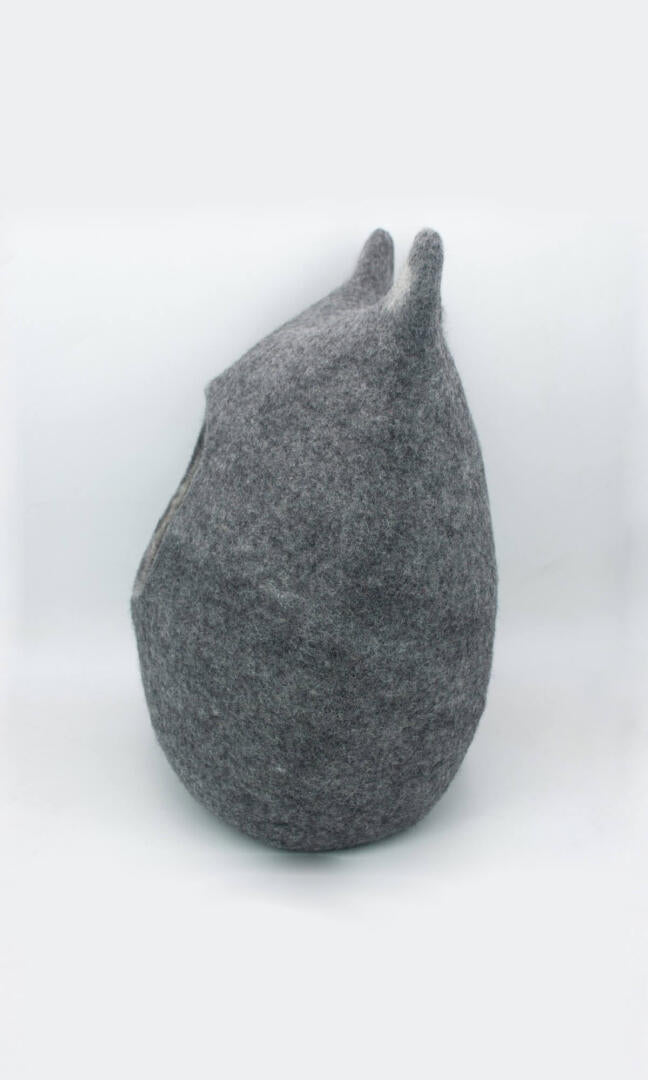 Image of Grey Feline Ear Cat Cave made from premium felted wool, providing a warm and comfortable hideaway for cats with unique cat ear design; a full side view.