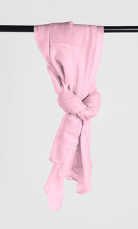Full view of the premium handwoven 100% pure Baby Pink cashmere shawl hanging from a bar to display its loop silhouette.