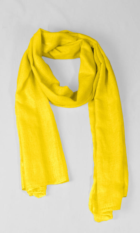 A detailed shot of the premium handwoven 100% pure Buttercup Yellow cashmere shawl in a season-less loop shape.