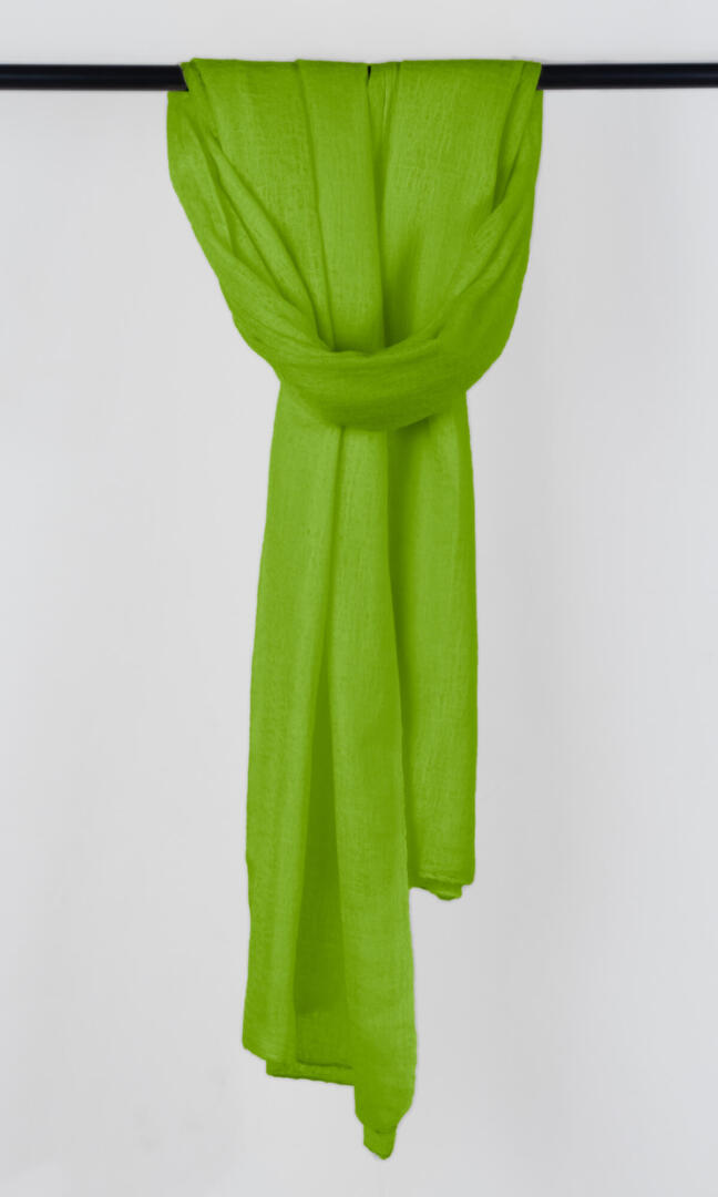 Full view of the premium handwoven 100% pure Chartreuse Green cashmere shawl hanging from a bar to display its silhouette.