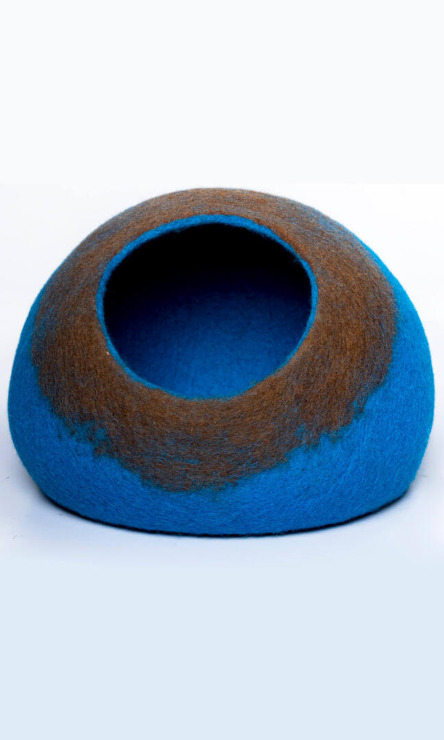 An oval-shaped cat cave bed in french blue based with a brown entrance, and a full front view.