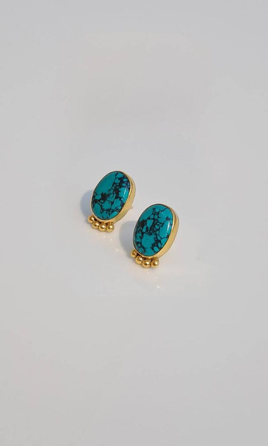 Stunning handcrafted Regal Turquoise Drop Earrings are expertly crafted with genuine, hand-cut turquoise stones - angled view.