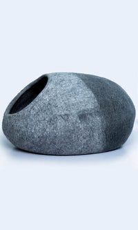 Image of the two-tone handmade felted wool cat cave, providing a warm and comfortable hideaway for cats with a comfortable entrance; a full left view.