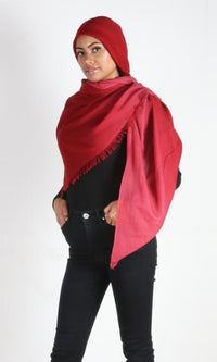 A female model displays a handmade two-tone red cashmere shawl wrapped around her head as a hijab scarf.